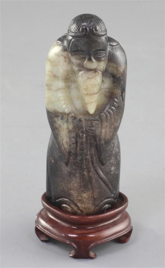 A Chinese white and black jade figure of a sage, possibly Han dynasty, height 9.1cm, wood stand